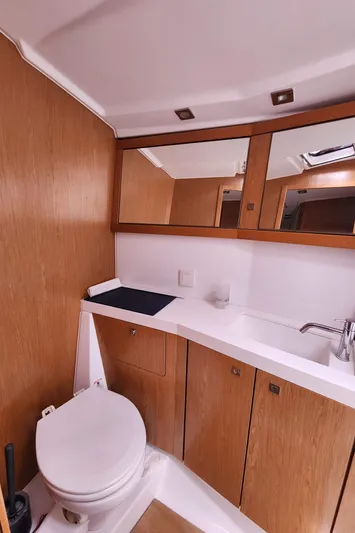 Jump Off Yacht Photos Pics Beneteau Sense 50 2011 yacht bathroom with wooden cabinetry and modern fixtures.