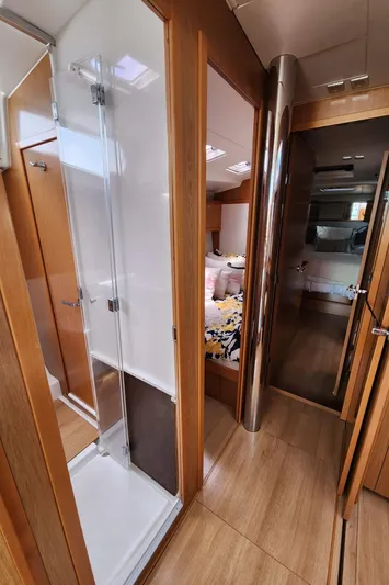 Jump Off Yacht Photos Pics Interior of 2011 Beneteau Sense 50 yacht, featuring a modern shower and cozy bedroom.