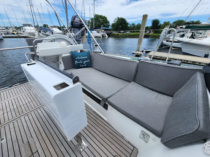 Jump Off Yacht Photos Pics Beneteau Sense 50 yacht deck with cushioned seating, docked at marina, 2011 model.