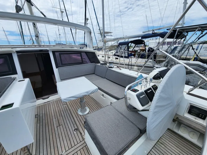 Jump Off Yacht Photos Pics 2011 Beneteau Sense 50 yacht cockpit with seating and helm, docked at marina.