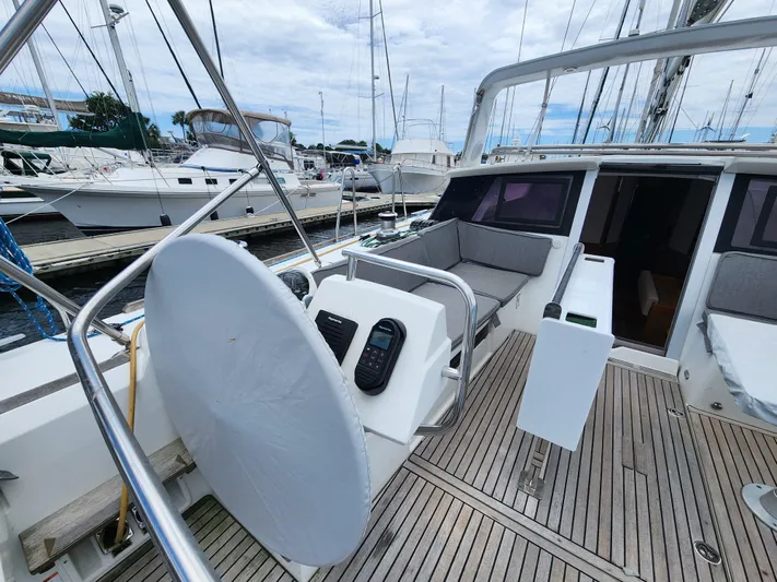 Jump Off Yacht Photos Pics 2011 Beneteau Sense 50 yacht cockpit with steering wheel and seating area.