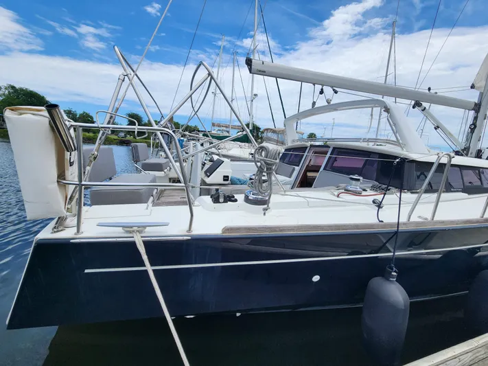 Jump Off Yacht Photos Pics 2011 Beneteau Sense 50 sailboat docked under a blue sky.
