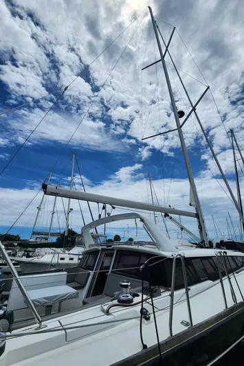 Jump Off Yacht Photos Pics 2011 Beneteau Sense 50 sailboat docked under a partly cloudy sky.