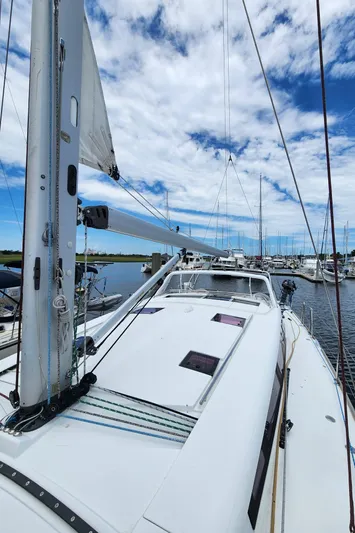 Jump Off Yacht Photos Pics 2011 Beneteau Sense 50 sailboat docked in marina under blue sky.