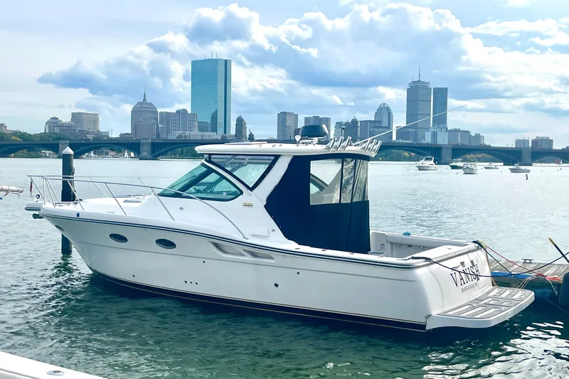 Vanish Yacht Photos Pics 2006 Tiara Yachts 3200 Open docked with city skyline in background.