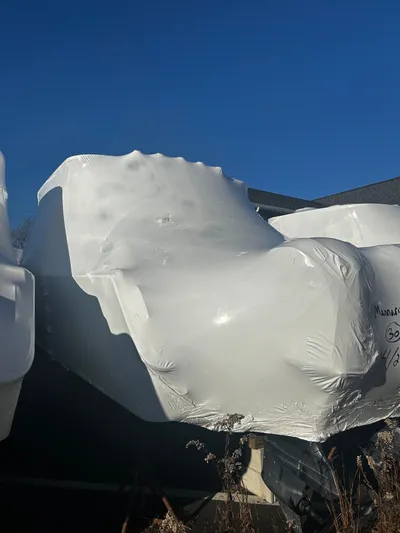  Yacht Photos Pics Wrapped Grady-White 307 boat, 2011 model, under clear blue sky.