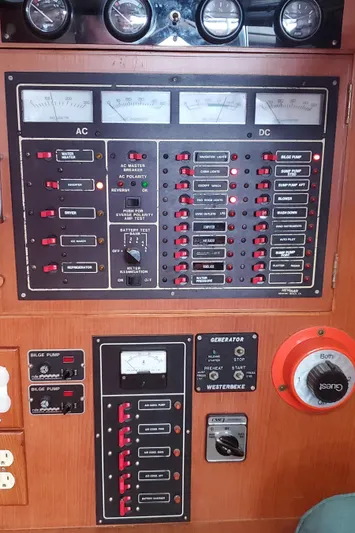 Tapestry Yacht Photos Pics Electrical control panel on a 1989 Tayana 55 yacht, featuring AC and DC meters.