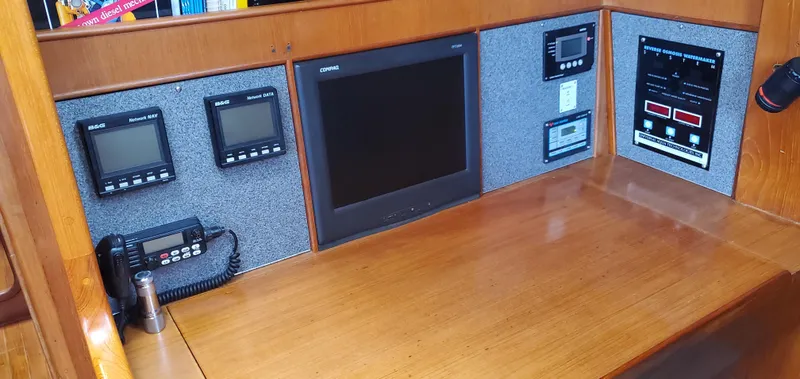 Tapestry Yacht Photos Pics Navigation station of 1989 Tayana 55 yacht with electronic displays and communication equipment.