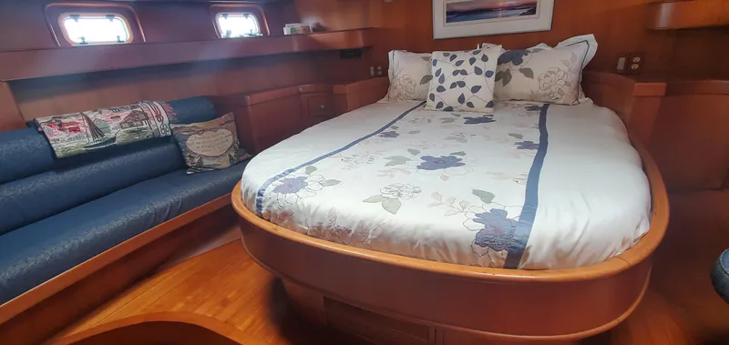Tapestry Yacht Photos Pics Cozy bedroom in 1989 Tayana 55 yacht with elegant wood finish and floral bedding.