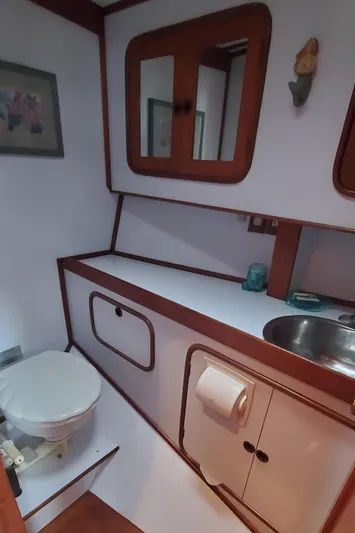 Tapestry Yacht Photos Pics 1989 Tayana 55 yacht bathroom with wooden accents and compact design.