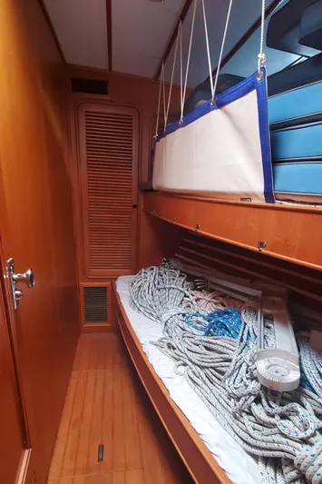 Tapestry Yacht Photos Pics Interior of 1989 Tayana 55 sailboat with ropes on a wooden bunk.