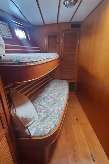 Tapestry Yacht Photos Pics 1989 Tayana 55 yacht interior with wooden bunk beds and cozy cabin design.