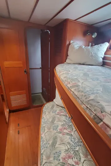 Tapestry Yacht Photos Pics Interior of 1989 Tayana 55 yacht with wooden bunk beds and floral bedding.