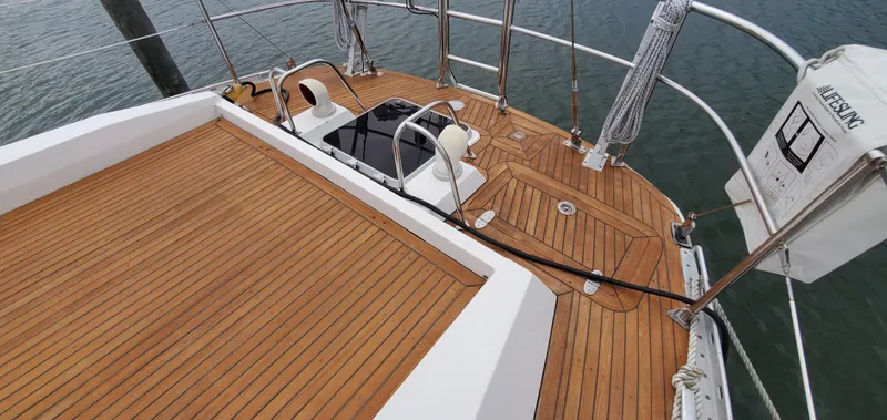 Tapestry Yacht Photos Pics Teak deck of 1989 Tayana 55 sailboat with lifebuoy and railing.