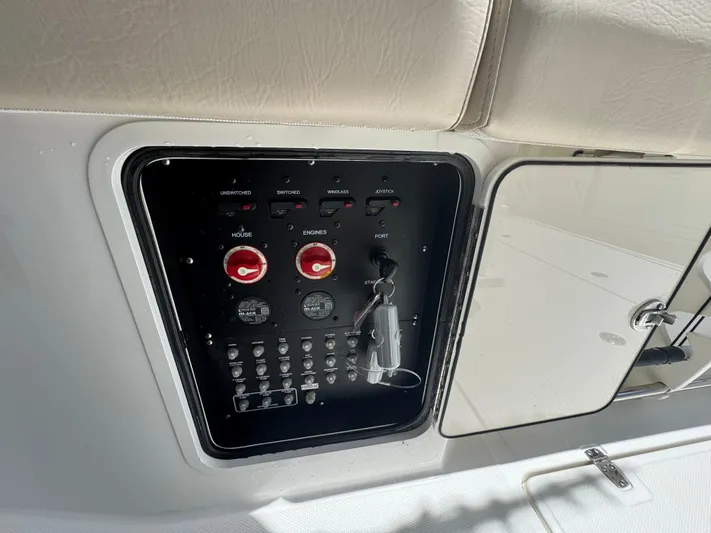  Yacht Photos Pics Control panel of a 2016 Boston Whaler 330 Outrage boat, featuring switches and keys.