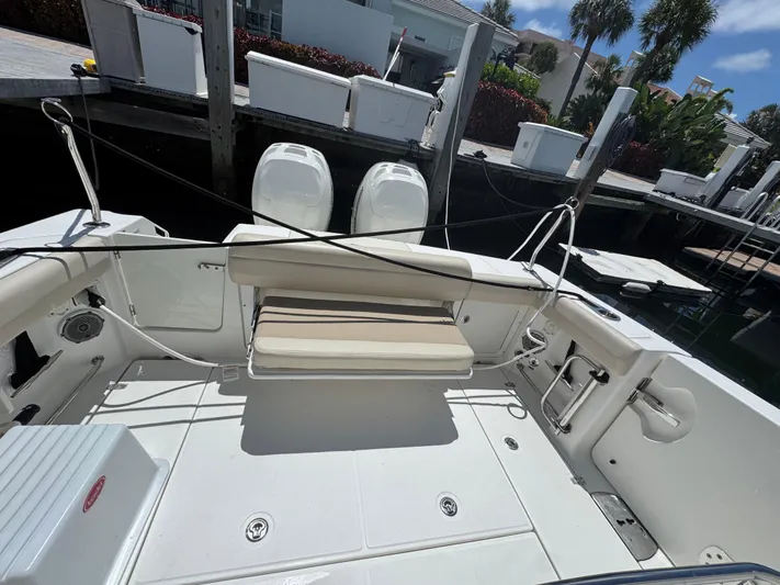  Yacht Photos Pics 2016 Boston Whaler 330 Outrage boat interior with seating and dual engines at dock.