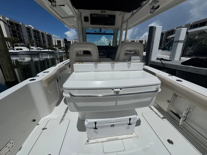  Yacht Photos Pics 2016 Boston Whaler 330 Outrage boat interior at marina, showcasing seating and storage.
