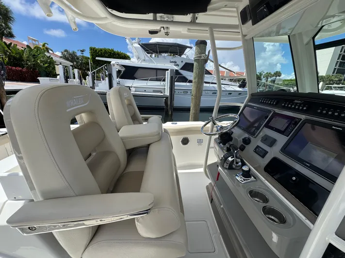  Yacht Photos Pics 2016 Boston Whaler 330 Outrage cockpit with modern controls and comfortable seating.