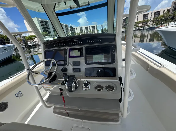  Yacht Photos Pics 2016 Boston Whaler 330 Outrage helm with modern controls and marina view.