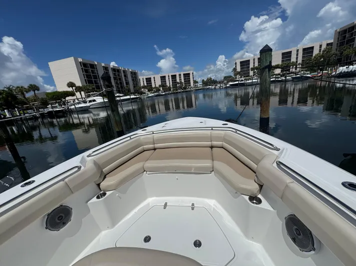  Yacht Photos Pics 2016 Boston Whaler 330 Outrage boat docked in a marina with waterfront buildings.