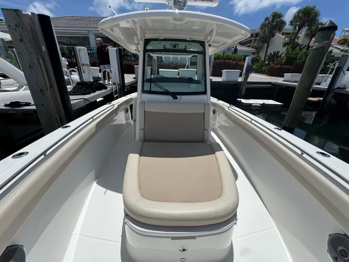  Yacht Photos Pics 2016 Boston Whaler 330 Outrage boat docked, featuring spacious seating and sleek design.