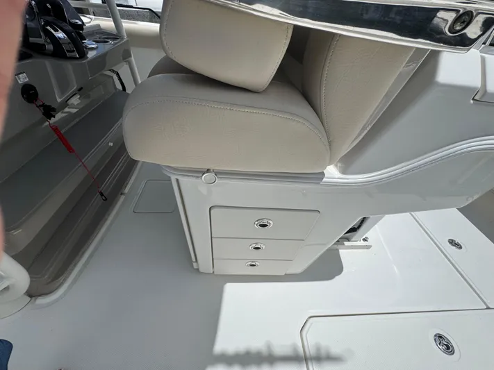  Yacht Photos Pics Interior of 2016 Boston Whaler 330 Outrage boat, featuring seating and storage compartments.