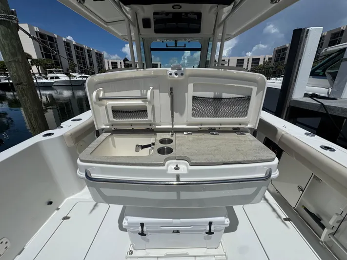  Yacht Photos Pics Boston Whaler 330 Outrage 2016 boat interior with open storage compartments at marina.