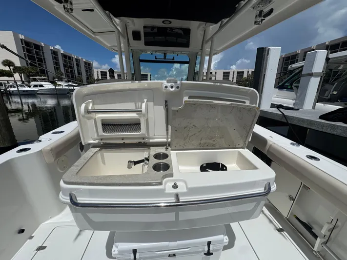  Yacht Photos Pics 2016 Boston Whaler 330 Outrage boat interior with open storage compartments at marina.