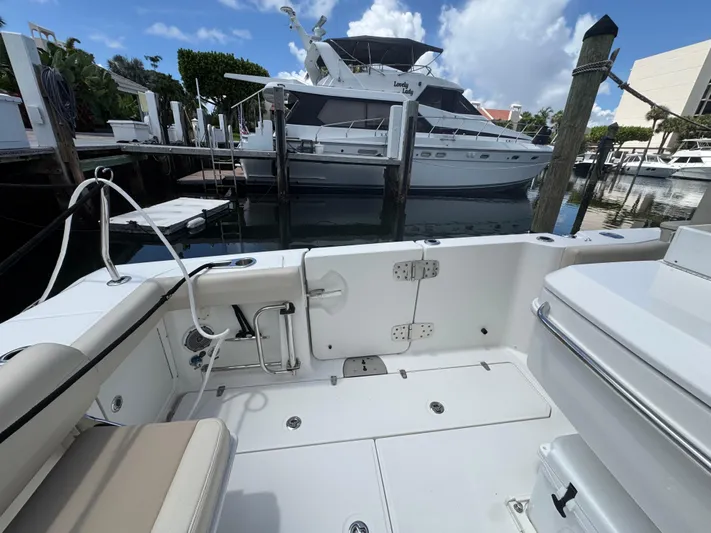  Yacht Photos Pics Boston Whaler 330 Outrage 2016 boat interior at marina with yacht in background.