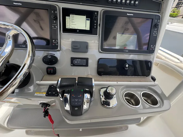  Yacht Photos Pics Control panel of a 2016 Boston Whaler 330 Outrage with navigation screens and controls.