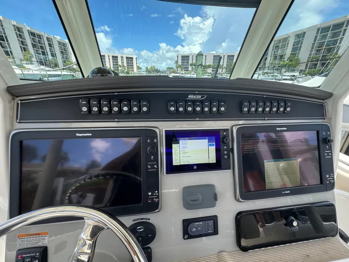  Yacht Photos Pics Helm of 2016 Boston Whaler 330 Outrage with Raymarine displays and control panel.