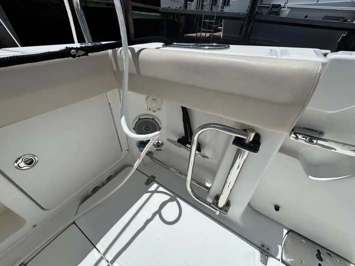  Yacht Photos Pics 2016 Boston Whaler 330 Outrage interior, featuring seating and stainless steel fixtures.