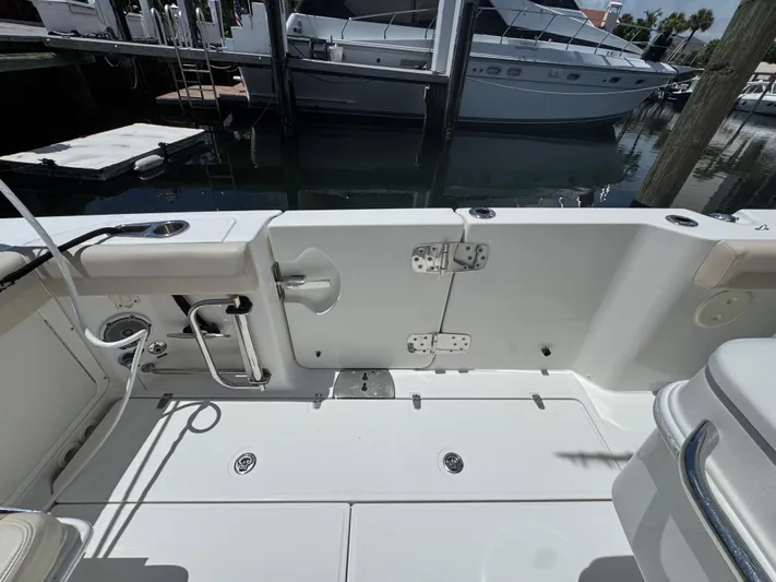  Yacht Photos Pics 2016 Boston Whaler 330 Outrage boat interior, featuring clean deck and fishing rod holders.