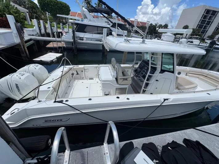  Yacht Photos Pics 2016 Boston Whaler 330 Outrage docked, featuring dual Mercury outboard engines.