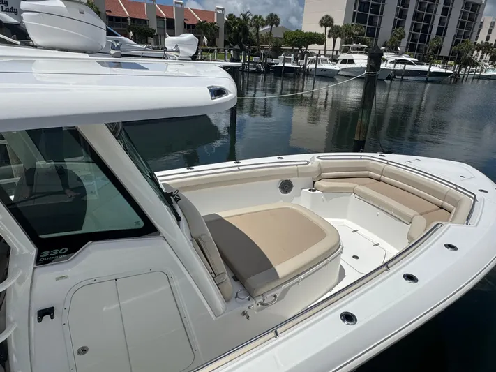  Yacht Photos Pics 2016 Boston Whaler 330 Outrage boat docked, featuring spacious seating and sleek design.