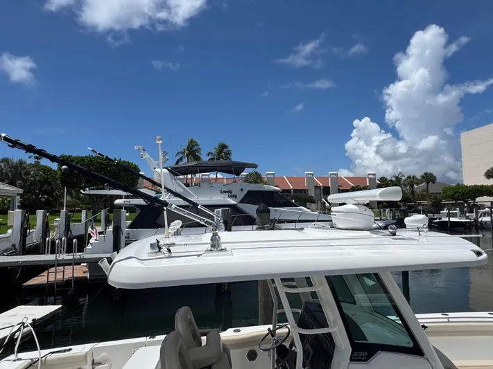  Yacht Photos Pics 2016 Boston Whaler 330 Outrage docked under a clear blue sky.
