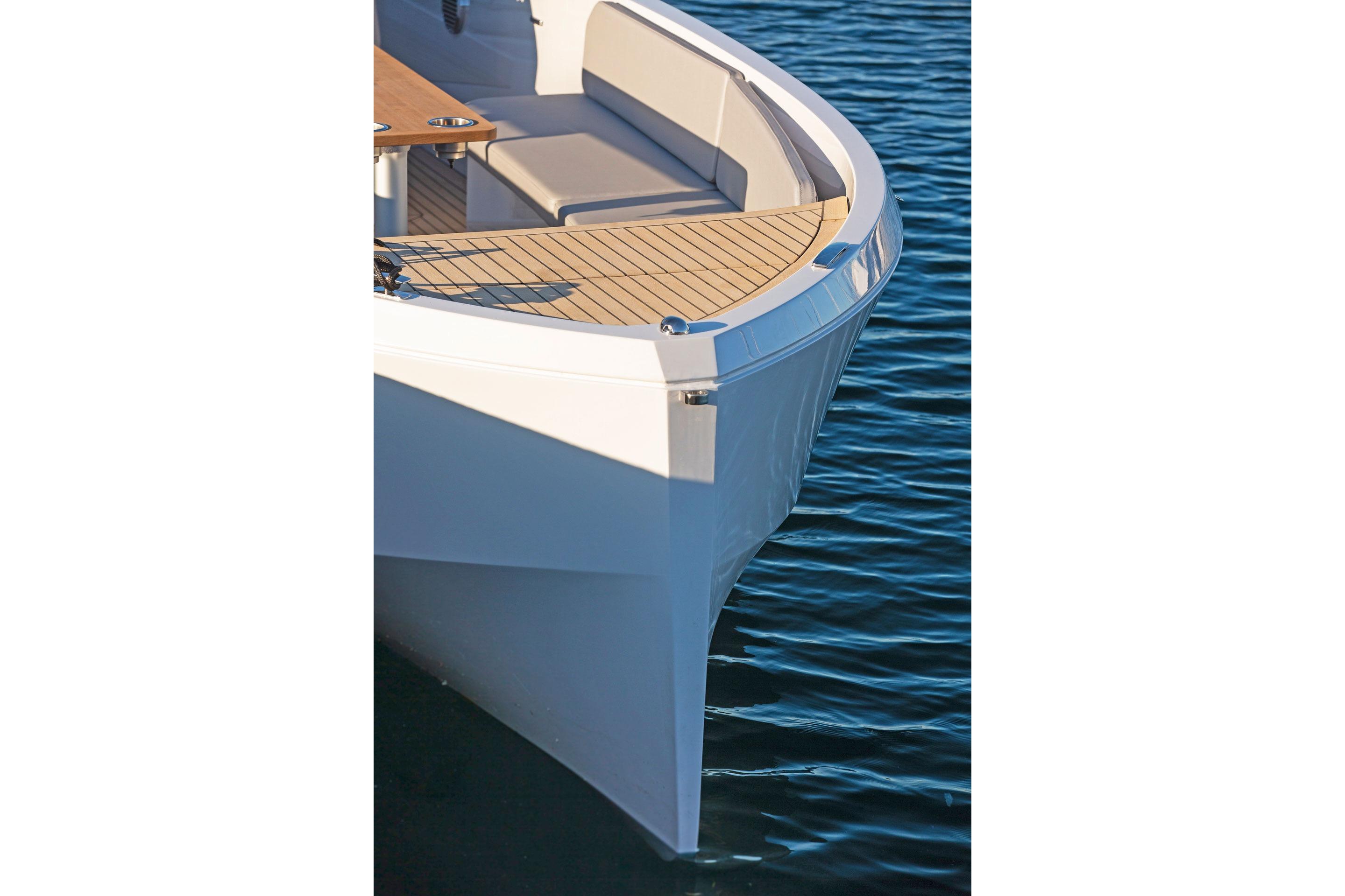 Rand Mana 23 boat, 2021 model, featuring sleek design and comfortable seating on calm water.