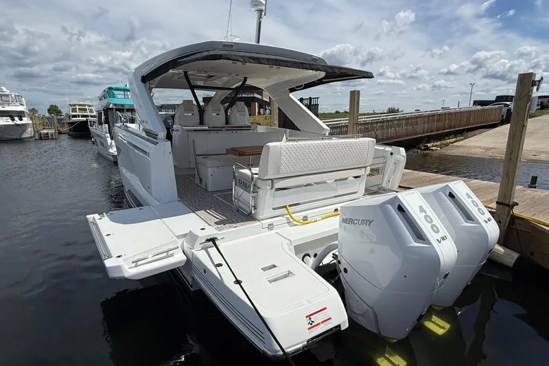  Yacht Photos Pics 2026 Jeanneau DB/37 OB boat with dual Mercury 400 engines docked at a marina.