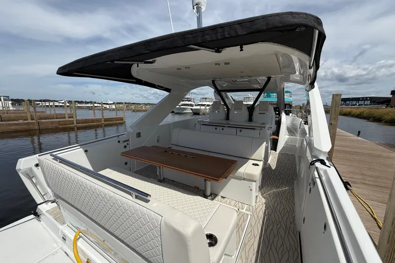  Yacht Photos Pics 2026 Jeanneau DB/37 OB luxury boat interior with seating and table, docked at marina.