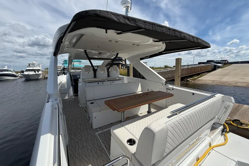  Yacht Photos Pics 2026 Jeanneau DB/37 OB luxury boat with spacious seating and elegant design at a marina.