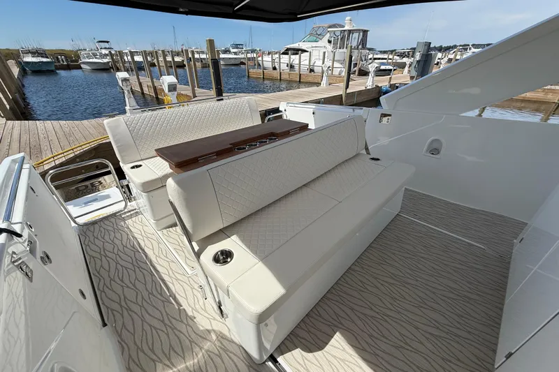  Yacht Photos Pics 2026 Jeanneau DB/37 OB boat interior with elegant seating at a marina dock.