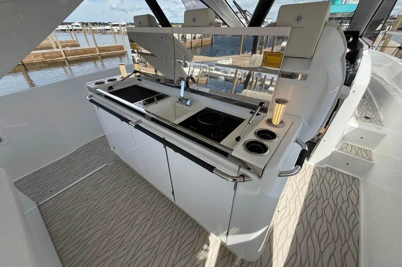  Yacht Photos Pics Modern kitchen area on 2026 Jeanneau DB/37 OB yacht with sleek design and waterfront view.