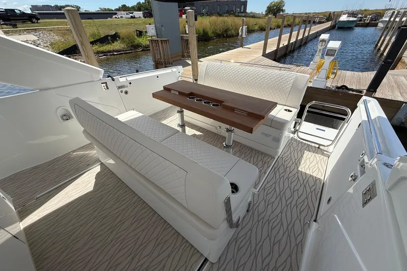 Yacht Photos Pics 2026 Jeanneau DB/37 OB boat interior with elegant seating and wooden table at marina.