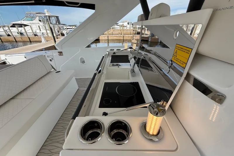  Yacht Photos Pics Luxurious 2026 Jeanneau DB/37 OB yacht interior with modern kitchen and seating area.