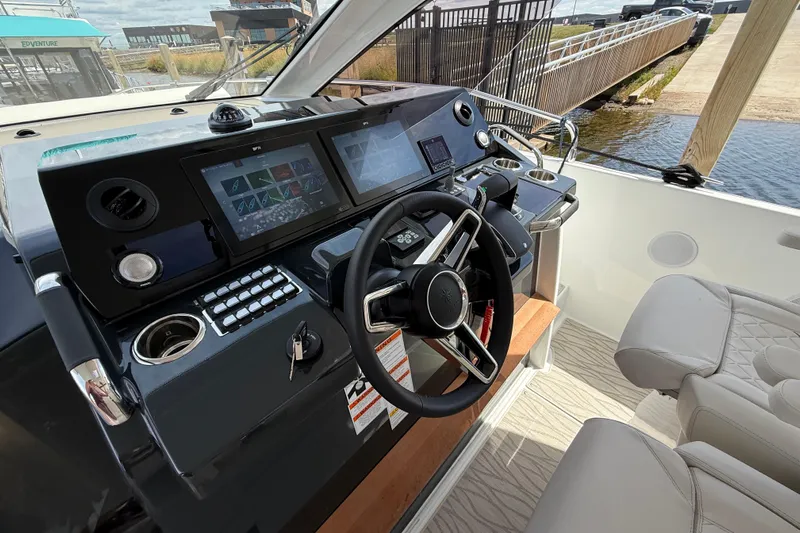  Yacht Photos Pics 2026 Jeanneau DB/37 OB boat cockpit with modern steering and navigation controls.