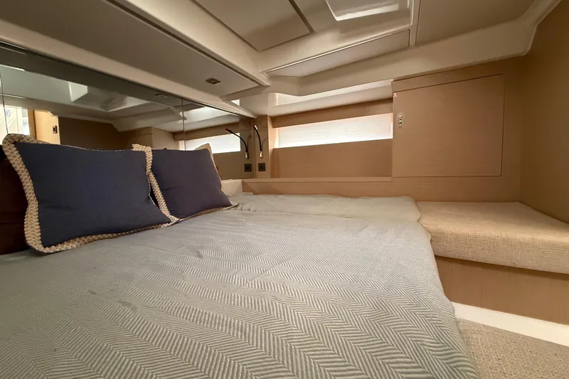  Yacht Photos Pics Luxurious cabin interior of 2026 Jeanneau DB/37 OB yacht with cozy bedding.