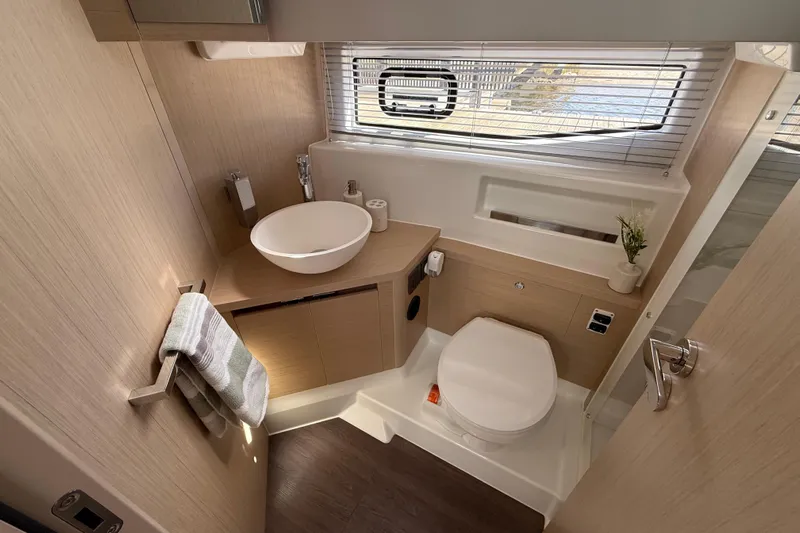 Yacht Photos Pics Modern bathroom interior of 2026 Jeanneau DB/37 OB yacht with sleek design and amenities.