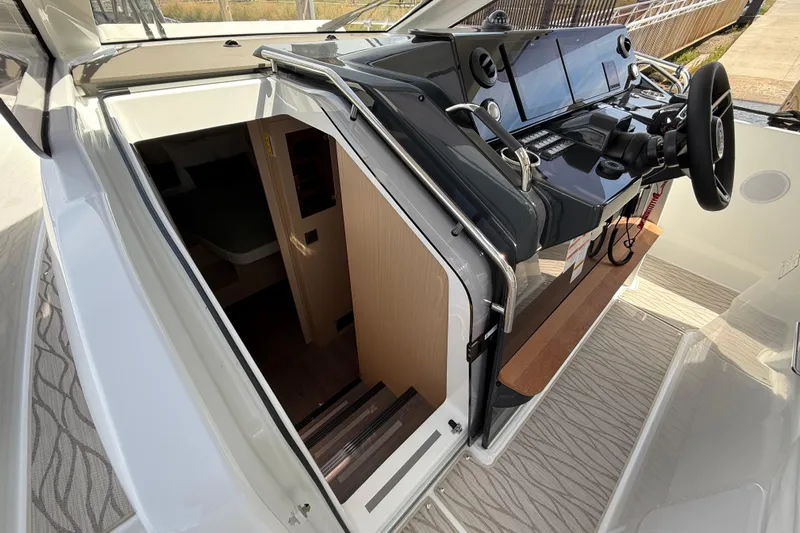  Yacht Photos Pics 2026 Jeanneau DB/37 OB boat interior with helm and cabin entrance.