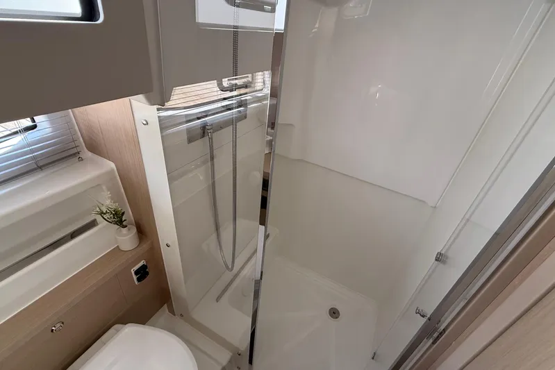 Yacht Photos Pics Modern bathroom interior of 2026 Jeanneau DB/37 OB yacht, featuring shower and sink.