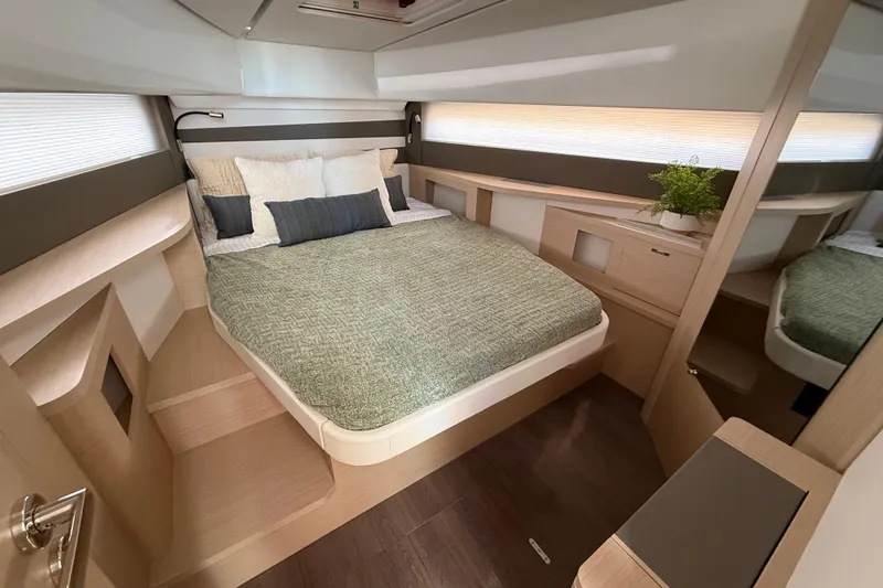  Yacht Photos Pics Luxurious cabin interior of 2026 Jeanneau DB/37 OB yacht with modern design and cozy bedding.